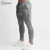 Siteweie Sportswearフィットネスパンツ男性ジムスキニースウェットパンツ屋外コットントラックパンツボトムジョガートレーニングズボンL244 210715