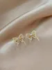 Orecchini femminili di vita semplice dell'arco dolce ed elegante della perla di cristallo dei gioielli di moda della Corea