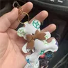 Nyckelringar Cow Nyckelkedjor Tillbehör Brun Flower Teddy Bear Pu Leather Car Keychains Rings smycken Kvinnor MÄNNING ANMÄRKNINGAR CHARMS PENDANT GENTER