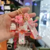 Creativo lindo Sakura conejo llavero de lujo flotante aceite botella flotante muñeca de dibujos animados llavero para mujer bolso llavero colgante G1019