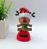 Creatieve zonne -energie schommelende poppen kerstcadeaus auto decoraties cartoon geschenken kinderen schudden hun hoofd speelgoed