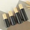 Tomma glaspumpflaskor påfyllningsbar svart frostat lotion eterisk oljesprayflaska med woodgrain plastlock 20 ml - 80ml sn2315