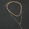 スタイリッシュなゴージャスなYタイプの長ペンダントシンプルな二重楕円形ビードチェーンゴールデン温度鎖骨ネックレスの女性ネックレスが積み重ねられています
