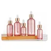 Botellas de perfume de aceite esencial de vidrio rosa, botella cuentagotas con pipeta con tapa dorada y tapa de goma blanca