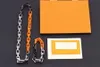 Europa Amerika Mode Ketting Armband Mannen Vrouwen Zilver Zwart Oranje-Kleur Metalen Gegraveerde V Letter Bloempatroon Dikke Ketting Sieraden Sets M68241 M69449
