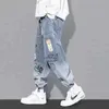 Jeans masculino Yoa outono nova impressão de letra jeans marca de moda masculina leggings soltos de desenhos animados grafite e calças de cordão 022023H