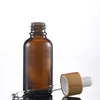 Botella de perfume de aceite esencial de vidrio ámbar Botella de goteta de la pipeta del reactivo de líquido con la tapa de bambú 5 ml a 100ml