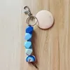 Le porte-clés de perles octogonales de silicone d'arc-en-ciel de commerce extérieur en gros peut être imprimé porte-clés rond