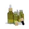 Couvercle en plastique en faux bois Bouteille en verre vert olive Emballage cosmétique Conteneurs rechargeables Flacons compte-gouttes en caoutchouc d'huile essentielle vide 5 ml 10 ml 15 ml 20 ml 30 ml 50 ml 100 ml