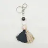 Foreign trade carved beaded wooden bead keychain personality two-color cotton tassel pendant key ring wholesale multi-color optional