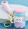 Macaron flutuante Macaron Quicksand Keychain Surfing Gato Frifting Garrafa Pingente Carro Bolsa Chaveiro Bag Anel para Menina E Mulheres Presente Acessórios Jóias