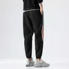 Jogging byxor män våren sommar utomhus sport lösa byxor 2021 nya panelade spliced ​​drawstring manliga trendiga sweatpants x0615