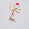 Kvinnor Populär Lila Blomma Guldfolieharts Initial Letter Keychain Med Tassel