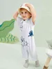 Baby dinosaur brief grafische polo nek jumpsuit zij