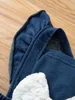 Barboteuse en jean avec nœud sur le devant et bordure à volants pour bébé fille SHE
