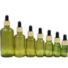 Couvercle en plastique en faux bois Bouteille en verre vert olive Emballage cosmétique Conteneurs rechargeables Flacons compte-gouttes en caoutchouc d'huile essentielle vide 5 ml 10 ml 15 ml 20 ml 30 ml 50 ml 100 ml