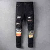 Jeans da uomo Pantaloni firmati da motociclista in difficoltà Pantaloni skinny slim strappati con lettera bucata Pantaloni in denim hip-hop di marca di alta qualità