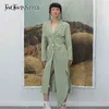 TWOTWINSTYLE Irregular Split Windbreaker For Female Lapel Collar Long Sleeve High Waist Hollow Out Drawstring Trench Coats Women 210825