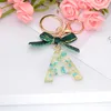 Porte-clés lettre anglaise bleue avec nœud papillon vert, jolies initiales A-Z, pendentif suspendu pour sac à main, accessoires