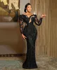 2022 Sexy Arabic Dubai Evening Dresses Wear Black Sequined Lace Bling Crystal Beads Long Sleeves Mermaid Plus Size Party Prom Gowns Cutaway Sides Floor Length