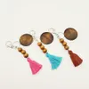 Le porte-clés personnalisé en perles de bois du commerce extérieur peut être imprimé rond et le porte-clés pendentif en pompon en coton multicolore en option