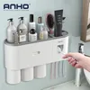 Portaspazzolino da parete Distributore automatico di spremiagrumi per dentifricio Adsorbimento magnetico Portaoggetti per tazza rovesciata Accessorio per il bagno 211130