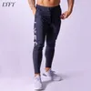 LYFT new men's sports casual pants solid color pants men's Youth Popular loose waist pants X0615