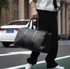 Fabrikverkauf Herrentasche handgewebte schwarze Handtaschen klassische gewebte Lederreisetaschen Outdoor-Reisen Fitness-Lederhandtasche