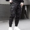 Осенние мужчины ленты сплошные цвета черные с карманными грузовыми брюками 2021 гарем пробежки мужской хараджуку бедра ударные брюки мужские