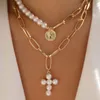 gold pearl cross pendant