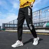 Bolsillos laterales para hombres Cargo Harem Pantalones Cintas Negro Hip Hop Casual Hombre Joggers Pantalones Moda Casual Streetwear Pantalones 220311