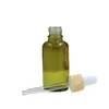 Couvercle en plastique en faux bois Bouteille en verre vert olive Emballage cosmétique Conteneurs rechargeables Flacons compte-gouttes en caoutchouc d'huile essentielle vide 5 ml 10 ml 15 ml 20 ml 30 ml 50 ml 100 ml