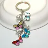 Porte-clés papillon coloré à la mode, sac de téléphone, sac d'école, pendentif papillon en perle, porte-clés en alliage, cadeaux pour femmes