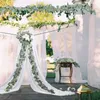 パーティーの結婚式の背景アーチの壁緑の人工的なユーカリの花輪の葉の装飾的な葉の手作りのシルクの花の黄色のフェイクフローラ