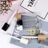 in stock 8ml clear packaging bottles transparent large brush bar lip oil color tube cosmetics lipstick package black white cover