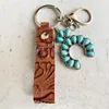 Keychains Vintage Echt lederen emboss Bloempolspolspompels Pompoen Blossoms Turquoise Cross Keychain Hoge kwaliteit Key Chain WholesalKeychai