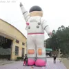 Doigt pointant vers le ciel rose grand modèle d'astronaute gonflable avec corde fixe et souffleur d'air pour publicité ou événement fabriqué par Ace Air Art