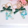 Keychains Fashion Green Bowknot 26 Letters Hars For Women Gold Foil Kerstcadeaus Bag Hanger Key Rings Charms AccessoriesKeyChains