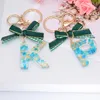 Llaveros Moda Verde Bowknot 26 Letras Resina Para Mujeres Hoja de Oro Regalos de Navidad Bolsa Colgante Llaveros Encantos Accesorios Llaveros