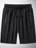 Летние черные сетчатые товарные затылки мужчины спортивная одежда для дышащих нейлоновых шорт -бриджей плюс размер.