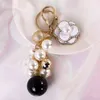 Crystal Camellia Keychain Luxury Jewelry Pearl Pendant Bag Decoration Pearl Chian Camellia Keychains For Woman AA220318