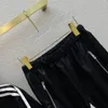 Luksusowy damski projektant prads dresowy dwuczęściowy garnitur Terry kurtka spodnie odzież sportowa trójkątna plakietka z nadrukiem pani w paski trencz w pasie