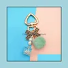 Key Rings sieraden mode parel ketting kristallen fles boog pompom sleutelhanger voor dames handtas ring auto pluizige puff ball sleutelhangers druppel levering