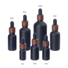 Garrafas de gotas de gotas de vidro fosco pretas perfumes de óleo essencial garrafa com tampa de plástico de grãos de madeira 5ml a 100ml SN4568