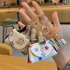 Läder nyckelkedjor ringer smycken brun blomma rutig tofs mynt handväska nyckelringar hänge mode mini förvaring väska charm nyckelchains tillbehör