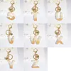 سحر جرس اللون الذهبي Alphabet Keychain English Lettering Keyring Glitter Resin Leaf Leaf Cark Cark Handbag Pendant keykain