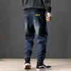 Herr jeans mode streetwear män lös passform skarvad designer last byxor harem slack botten hip hopp rippade joggersmen's