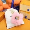 Designer Coulples Sunflower Key portefeuille Brand de luxe FAWN LION Hairball Sac à épaule BOTTES LUGGAGE PENDANT Brand Keychain Women Men 315p