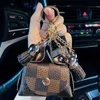 革製のキーチェーンリングジュエリーブラウンフラワープレイドタッセルコイン財布キーリングホルダーファッションミニストレージハンドバッグ