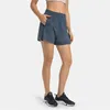 L-196 Shorts de sport décontractés pour femmes Pantalons courts de yoga à séchage rapide Pantalons de survêtement minces avec poches latérales Drop-In Élastique Fitness en plein air Pantalon à trois points